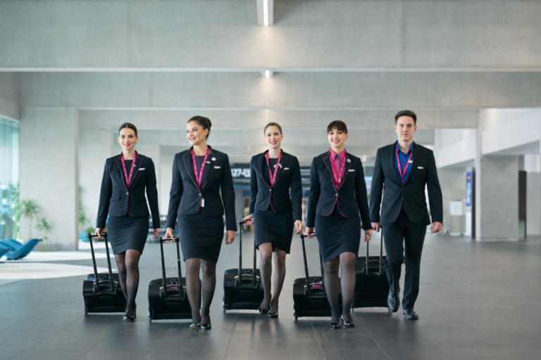 Wizz Air cabin crew walking through airport terminal